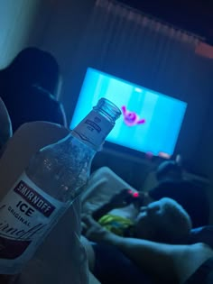 a bottle of water sitting in front of a tv