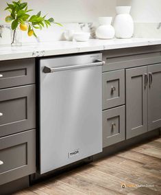 the dishwasher is sitting in the middle of the kitchen counter top, and it's stainless steel