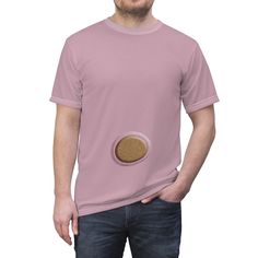 a man wearing a pink t - shirt with a cookie in the pocket on his chest