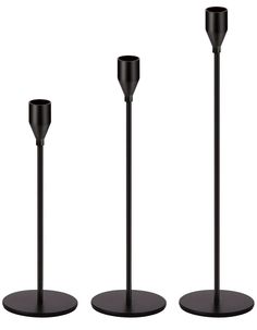 three black candles sitting on top of each other