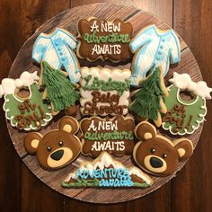 decorated cookies on a plate with baby's first year names and teddy bear decorations