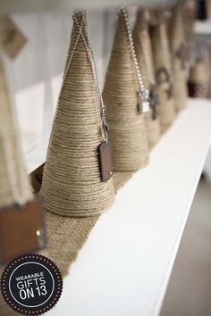 some burlap cones are hanging on a shelf with tags attached to them and the price tag is $ 15