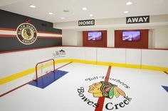 an indoor hockey rink with the chicago black hawks logo on it's side wall