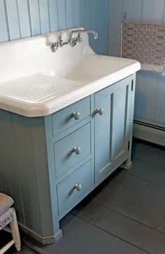 a white sink sitting under a bathroom mirror