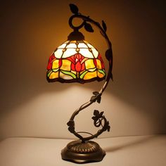 a stained glass lamp on top of a table