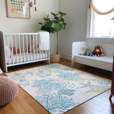 a baby's room with a crib, chair and rug