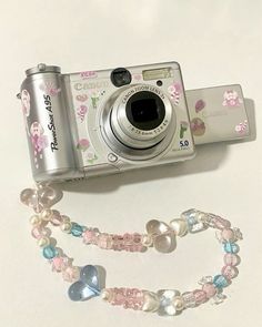 a camera and some beads on a table