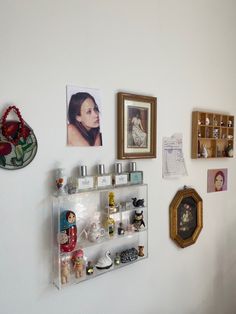 the wall is covered with pictures, photos and knick knacks on it