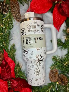 a white coffee cup sitting on top of a christmas tree