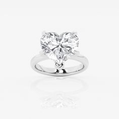 a heart shaped diamond ring on a white background