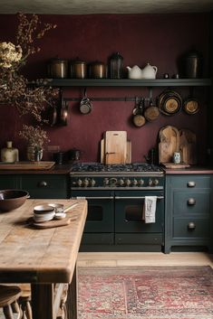 an old fashioned stove in a kitchen with red walls