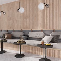 a room with three tables and two couches in front of a wall that has wood paneling on it