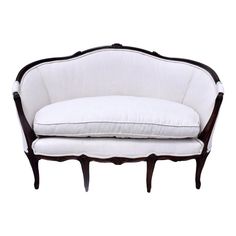 a white couch sitting on top of a wooden frame