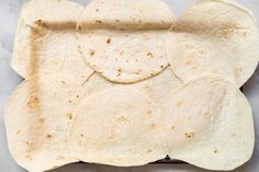 tortillas on a baking sheet ready to be cooked and put in the oven