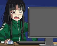 an anime character sitting at a desk in front of a computer monitor with her mouth open