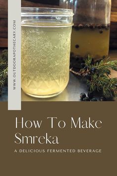 two jars filled with liquid sitting on top of a table next to pine cones and berries