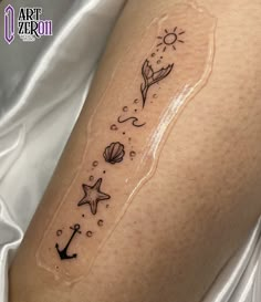 a woman's arm with an anchor and starfish tattoo on it