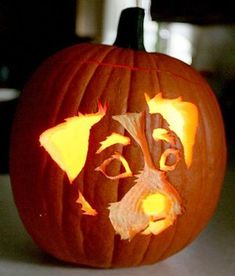 a carved pumpkin with a dog's face on it