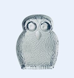 an owl glass figurine sitting on top of a table