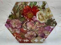 a bouquet of flowers on top of a glass plate with the letter c and i