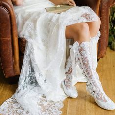 a woman is sitting in a chair with her legs crossed and wearing white lace garters