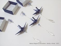 four origami birds are attached to strings with book pages in the back and inside