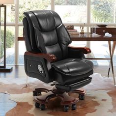 a black office chair sitting on top of a cowhide rug