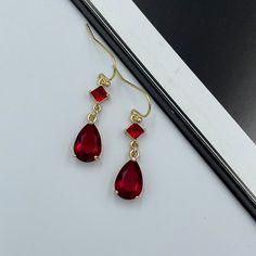 Dainty Ruby Red Thread Earrings, Dark Red Teardrop Earrings, Statement Ruby Red Drop Earrings, Long Red Dangle Earrings, Red Dangle Earrings. These are simple and beautiful red teardrop crystal earrings. Red crystals are framed in bright gold and dangling from gold plated French wire. Measurements: The total length from the top of the hook to bottom - 1.37 inches (35mm) approximately. Teardrop crystal: 12 mm x 7 mm The earrings would be a PERFECT GIFT for you and your family and friends! Click h Ruby Dangle Earrings, Red Teardrop Earrings, Ruby And Gold Earrings, Red Dangle Earrings, Dark Red Jewelry, Black And Red Earrings, Ruby Aesthetic, Homecoming 2023, Dark Red Earrings