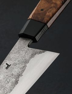 a close up of a knife with a wooden handle