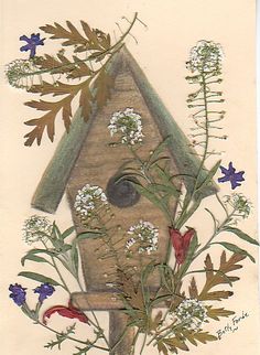 a bird house surrounded by flowers and leaves