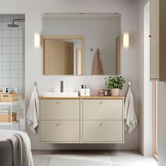 a bathroom with a sink, mirror and bathtub in it's center area