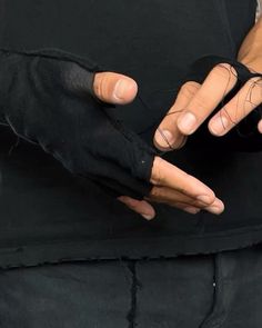 a person with their hands wrapped in black cloth