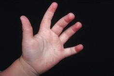 a baby's hand reaching up into the air with it's palm out