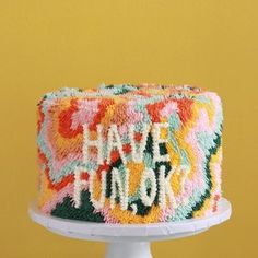 a colorful cake with the words happy new york on it's icing and frosting