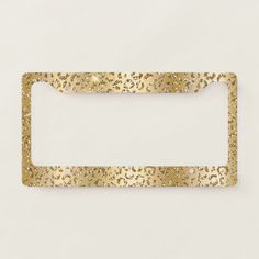 a gold metal license plate with small holes in the front and bottom, on a white background