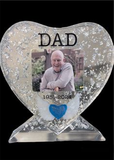 a heart shaped glass with the words dad on it and an image of a man