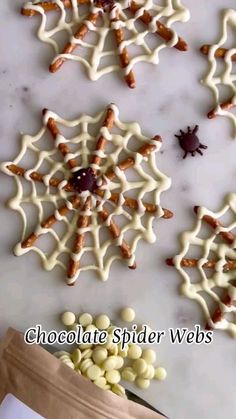 chocolate spider webs and candies are on the counter next to a bag of candy