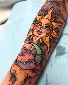 a sun and moon tattoo on the arm