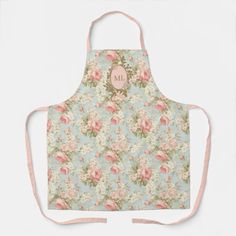 an apron that has flowers on it with the letter u in pink and green colors