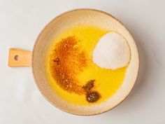 a bowl filled with yellow liquid and spices