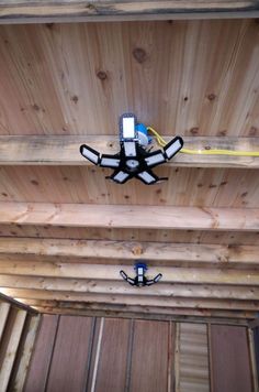 the ceiling is covered with wood planks and has two lights on each side of it