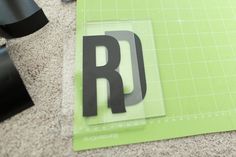 the letter r is cut up on top of a cutting mat