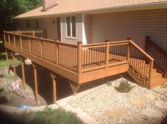 a wooden deck in front of a house