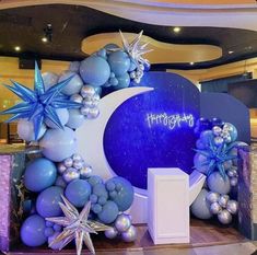 a large balloon arch decorated with stars and balloons