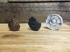 three different types of chocolates sitting on top of a wooden table