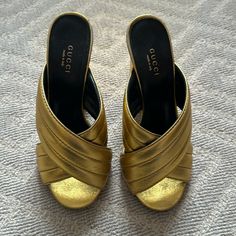 Gucci Gold Webby Cross Over Sandals. Please Note Condition In Photos. Size 37. Heel Is 4.25. Luxury Closed Toe Mules With 4-inch Heel, Luxury Gold Mules With Block Heel, Luxury 4-inch Heel Closed Toe Mules, Designer Gold Sandals With Heel Loop, Designer Mules With 4-inch Heel, Designer Gold Sandals With Wrapped Heel, Gucci Sandals With Branded Heel Counter, Luxury Mules With 4-inch Heel And Round Toe, Gucci Designer Sandals For Formal Occasions