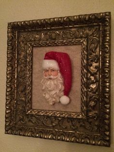 there is a framed photo with a santa clause on it