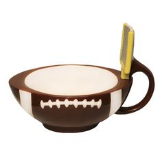 a brown and white bowl with a toothbrush in it