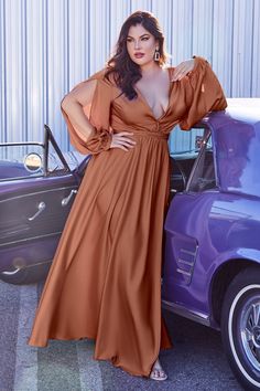 Look chic in this plus size long blouson sleeve satin dress by Cinderella Divine 7475C from their Curve Collection. Cut from a soft satin, this floor length gown features romantic split blouson sleeves, a pleated wrap-effect bodice and deep V-neckline. The gathered A-line skirt features a thigh-grazing split so you can show a little leg. This dress is the embodiment of elegance, beauty and ease. Curvy Satin Long-Sleeved Gown Deep V-neck bodice with split blouson sleeves Open V-back Floor length Long Sleeve Satin Dress, Cinderella Divine, Plus Size Prom, Satin Long Sleeve, Cinderella Dresses, Long Sleeve Gown, Bridesmaid Dresses Prom, Floor Length Gown, Satin Gown