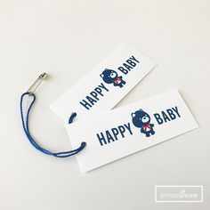 two tags with the words happy baby and a bear on them sitting next to each other